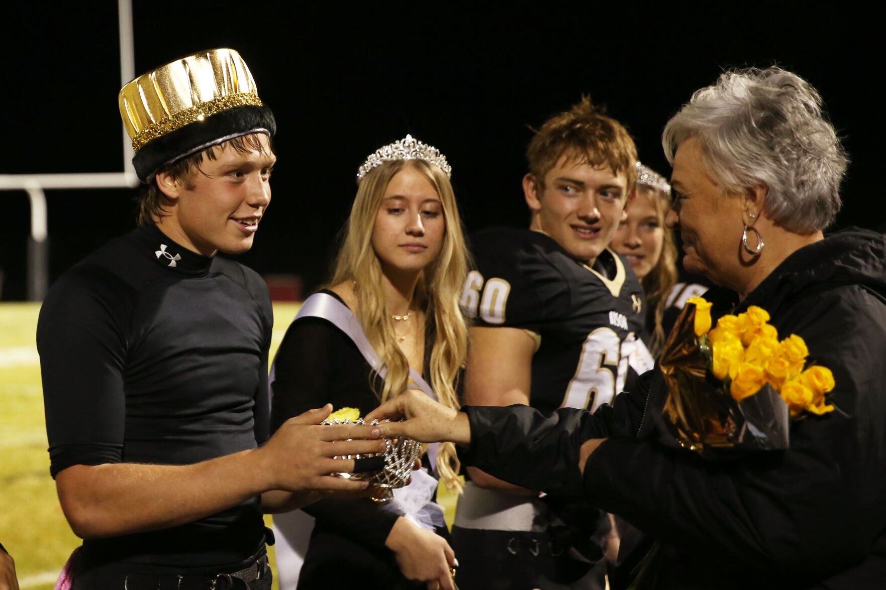 Homecoming King Ben Camino received his bright gold crown